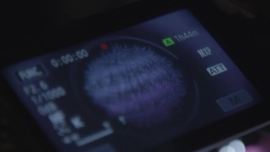 Close view of some type of digital display with a circular noise pattern in the center