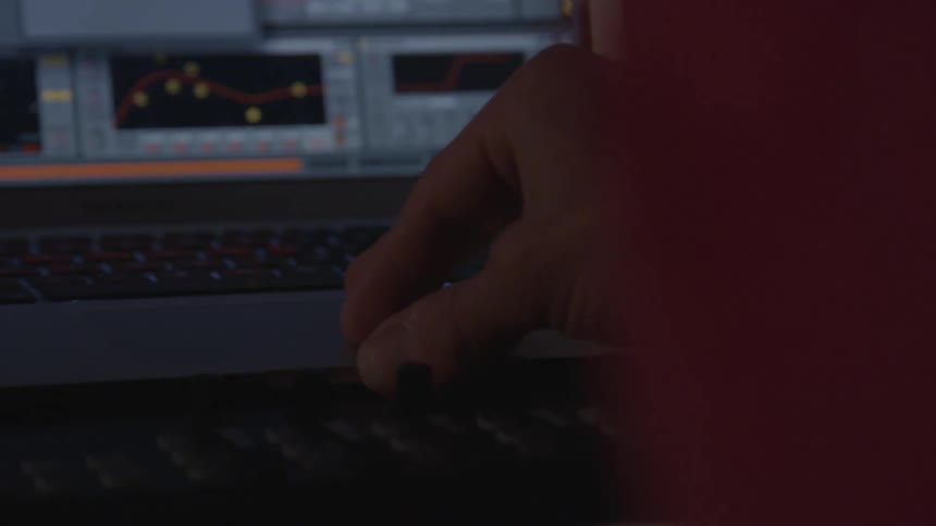 A man is playing on a computer