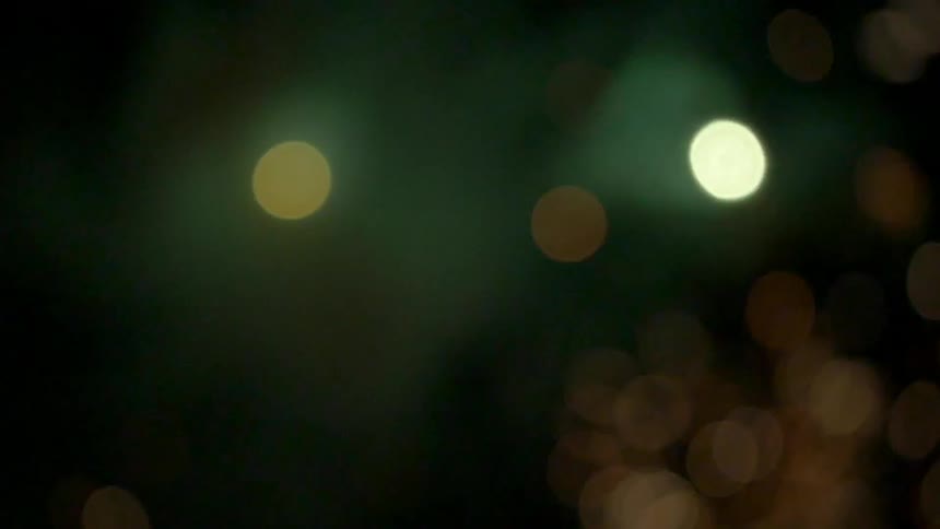 Lights sparkle and flash against a dark background