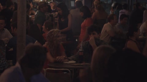 A crowd hanging out at the bar