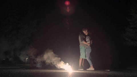 A couple is kissing in a road