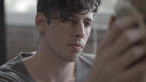 A man caresses a woman's face