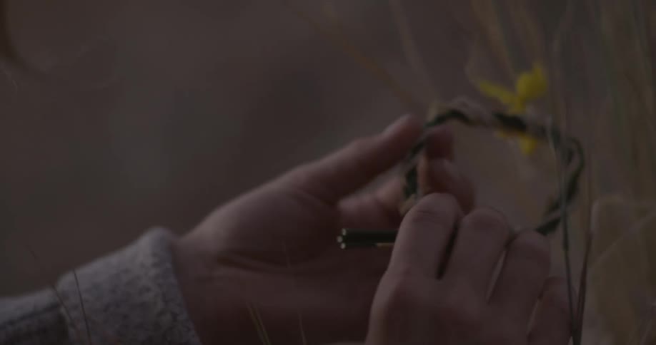 Girl puts on a hand made flower bracelet