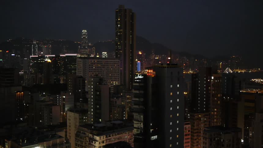 Skyscrapers loom against the night sky