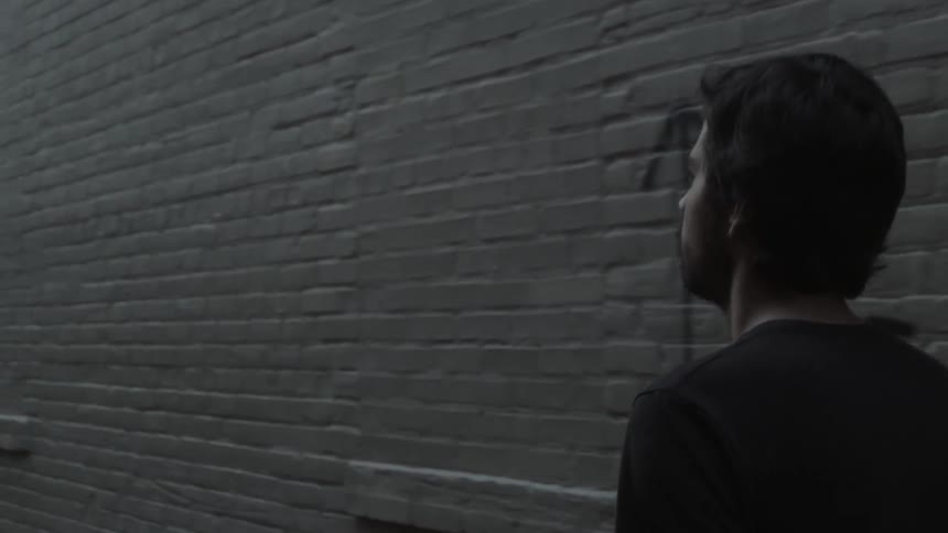 A person waling down an alley