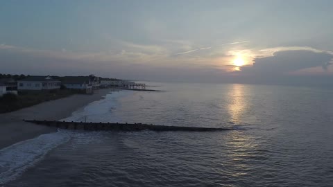 Aerial view of the ocean side at sunset