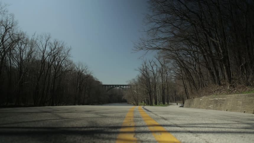 Person racing down a highway on a motorcycle