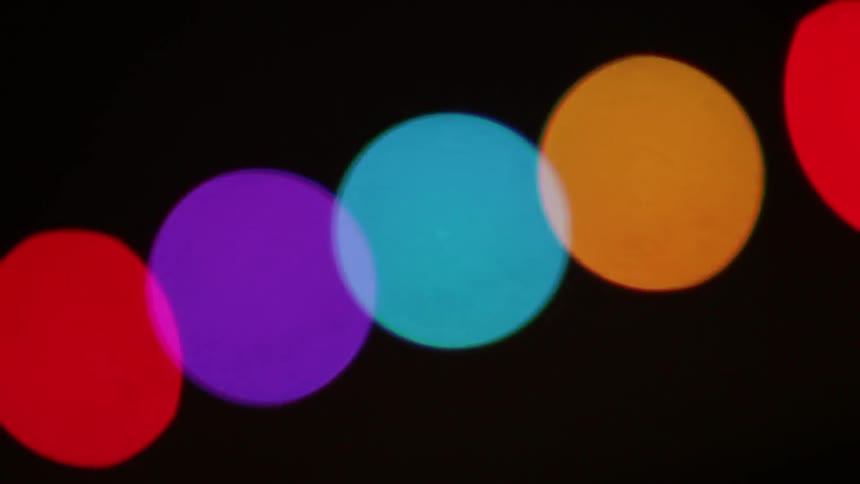 Brightly colored circles moving in a chain