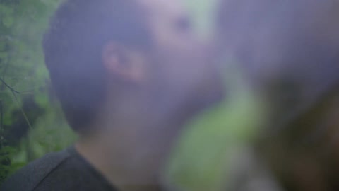 Man and woman smiling at each other outside