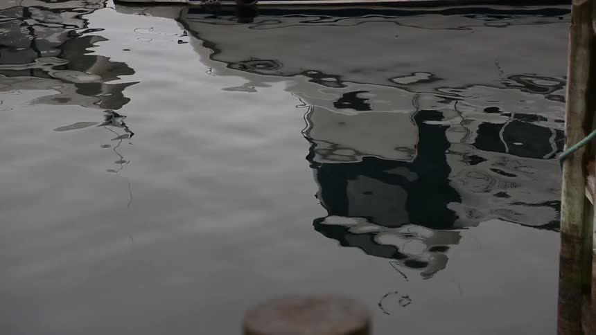 Rippling water reflecting a boat