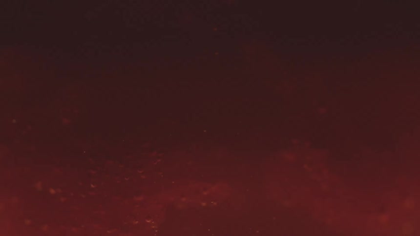 Particles floating in a red colored liquid