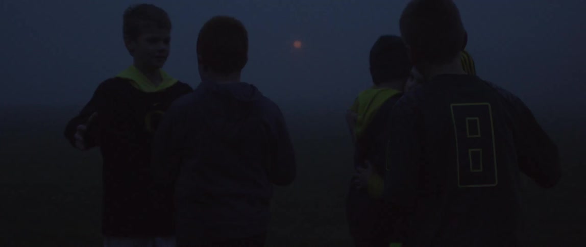 A group of young boys congratulate one another
