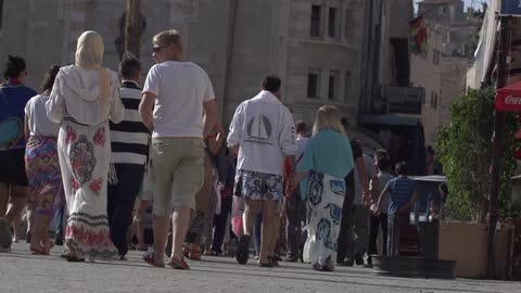 People taking a stroll down a city street