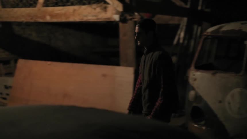 A man turning a lamp on in the garage