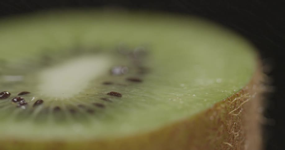 A cut half of a kiwi