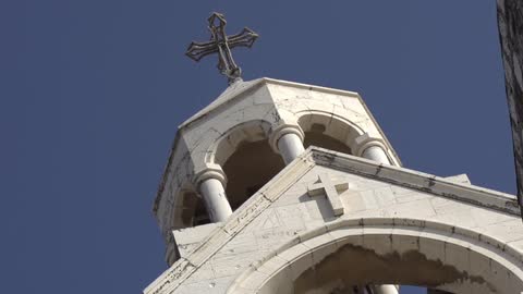 The top of a church with a cross steeple