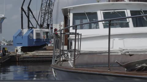 A boat bobs in the water while tied up at a dock