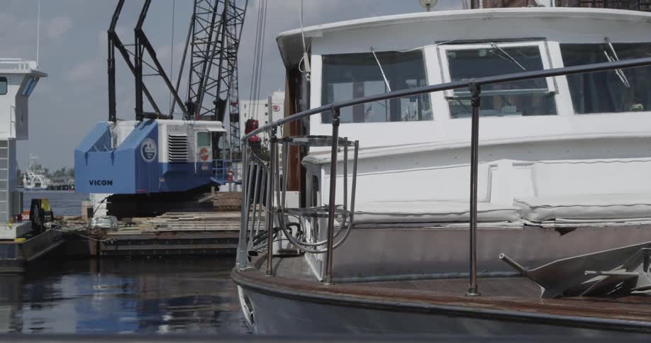 A boat bobs in the water while tied up at a dock