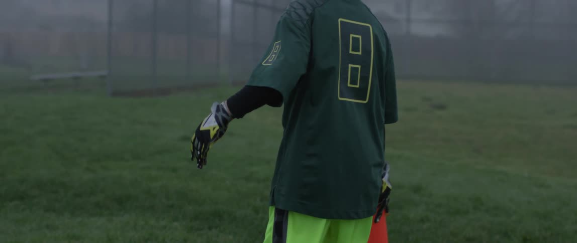 A young football player moves a cone