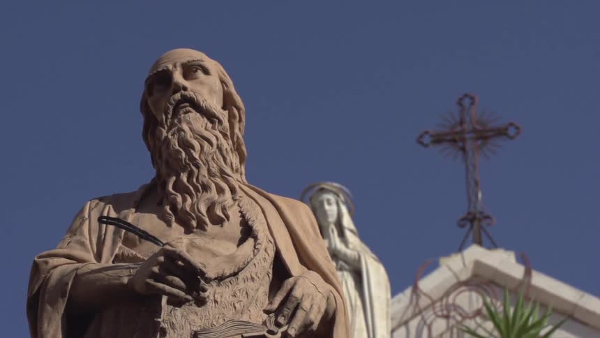 Two religious statues in front of a church