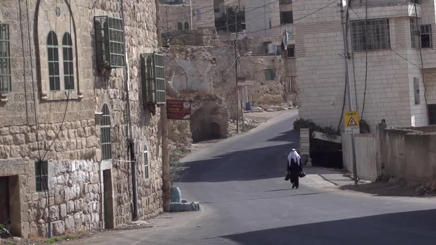A person walking on a lonely road in the city
