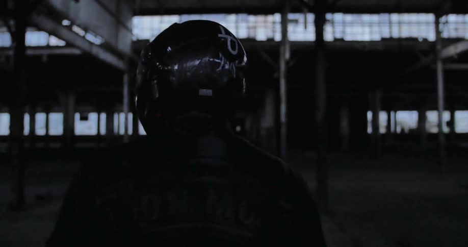 Man in a helmet walking inside an old building