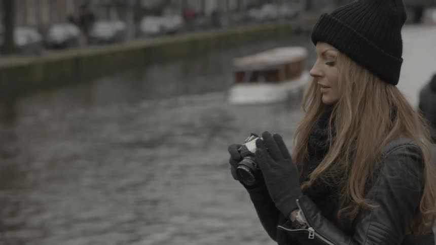 Woman taking pictures in a city on a cold day