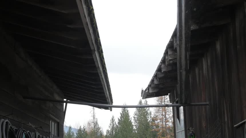 Rain dripping from the overhang of two houses