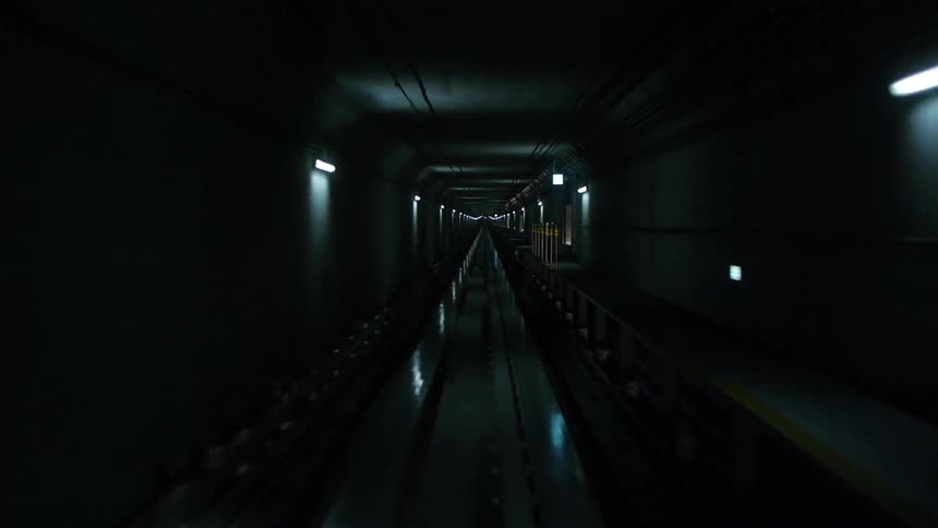 View from the front of a train moving on an underground subway track