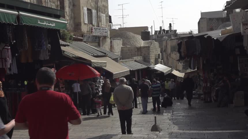 People strolling through the market on a bright sunny day