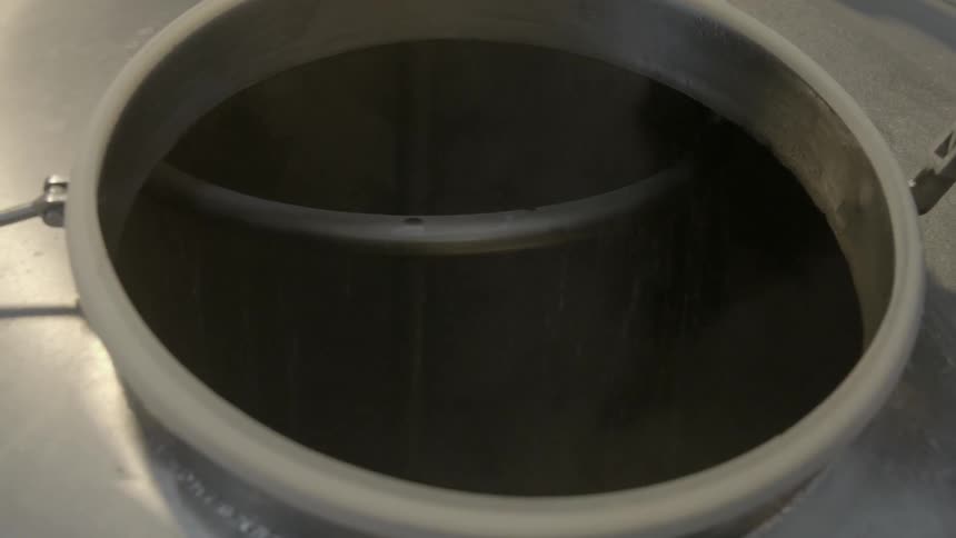 Container filled with steaming liquid