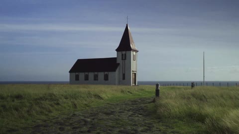 A small church off the shore of the ocean
