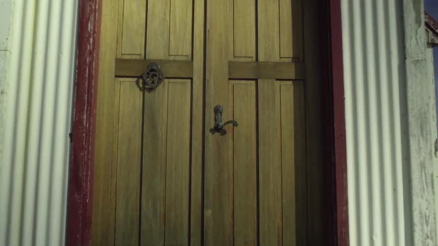 Camera moving in close on a door on a shack