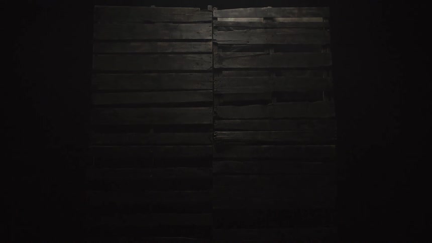 A wood wall inside a dark room