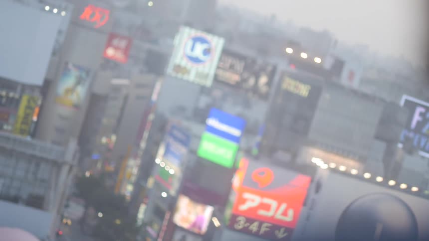 Man stares out his window at Tokyo city below him
