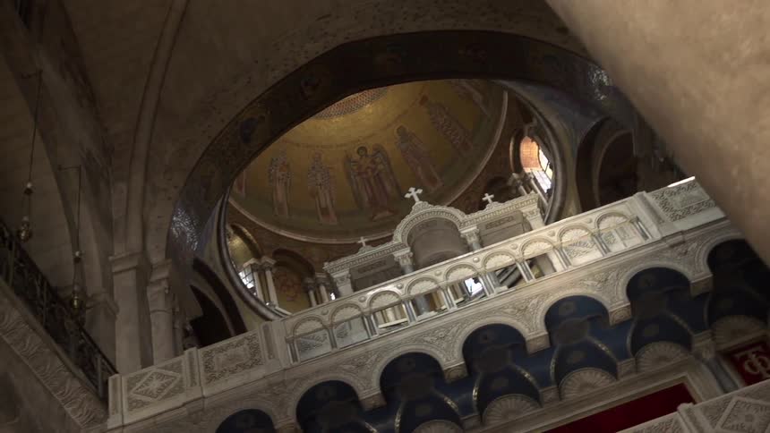 Panning view of the art on the ceiling of a church