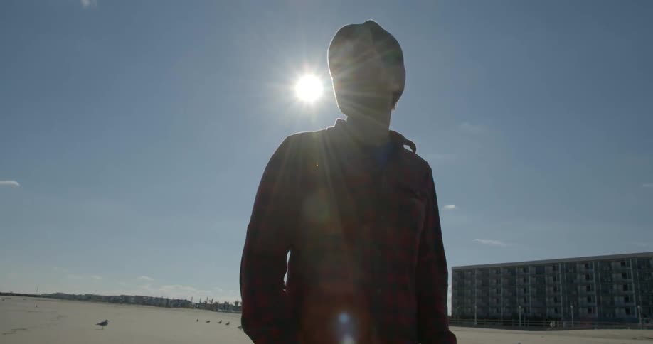 A man is looking around a beach