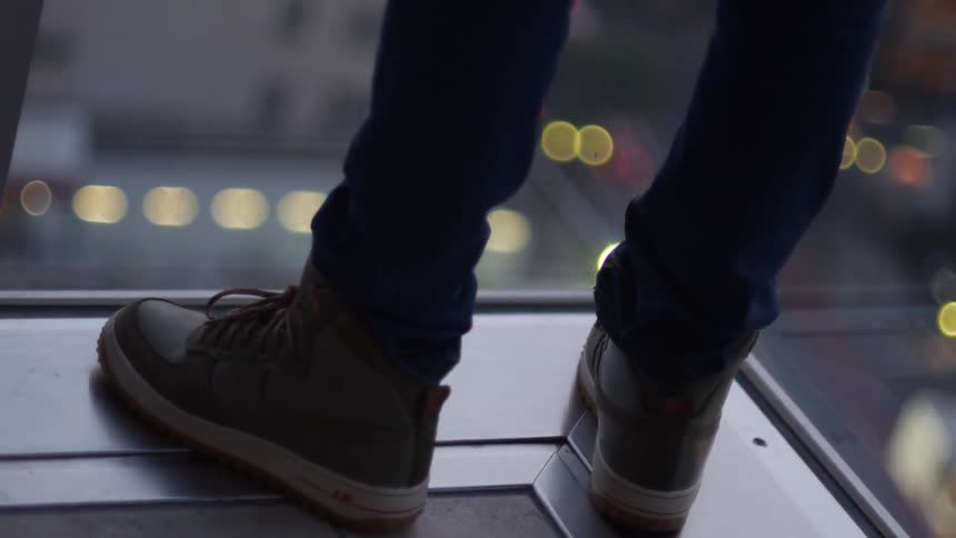 A person standing on the edge of a building