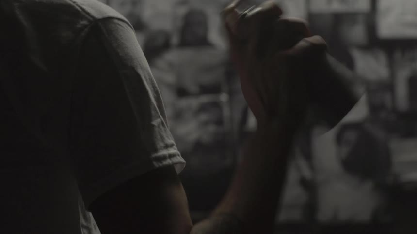 Man shaking up can of spray paint