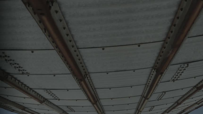 A metal ceiling with riveted supports