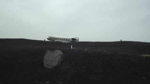 The passenger part of a plane is on the ground in an open field