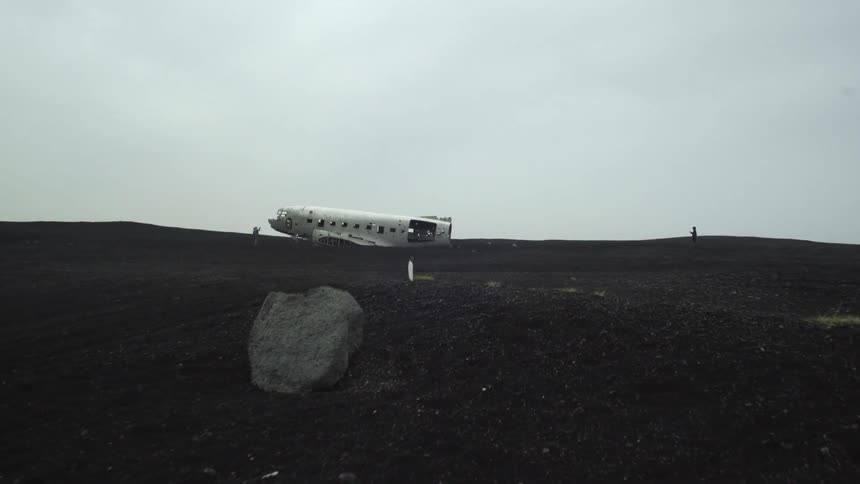The passenger part of a plane is on the ground in an open field