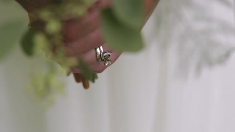 A bride and groom hold hands