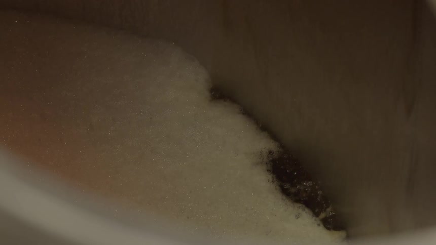Water pouring down into a bubbly tub