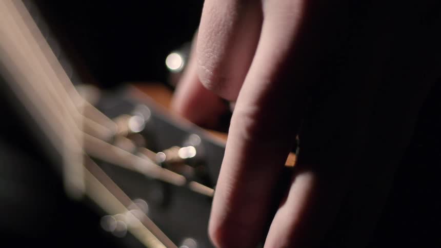 Close up of a person tuning a guitar