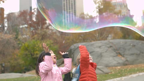 Children playing with a giant bubble