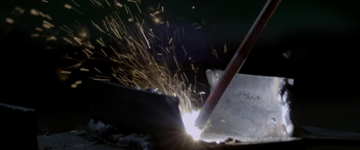Welding metal with sparks flying