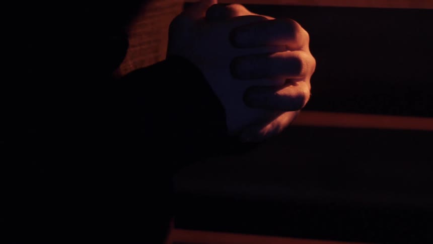 A nervous person rubs his hands in anxiety