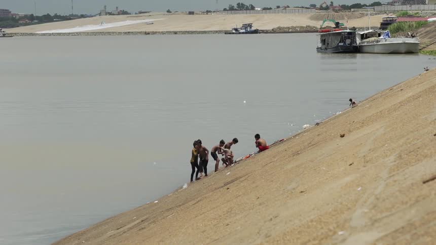 A group of children play in a lake