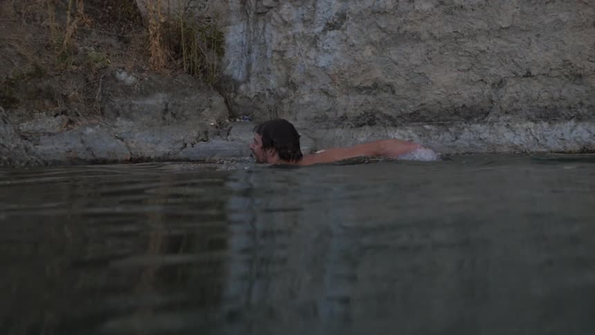 A man swims in a body of water
